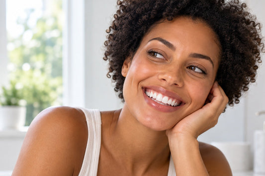 A smiling adult in soft natural daylight, illustrating how consistent lighting can help compare teeth-whitening progress more fairly.